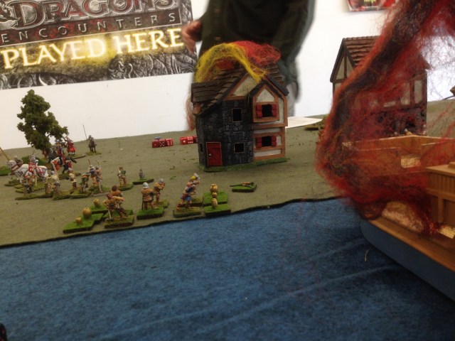 Playtest photo.  The English land in the lower town, setting afire a waterfront building and a ship 