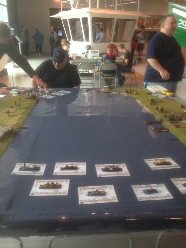 Confederate ram fleet in the foreground, looking down the river as the Union forces prepare their advance. 